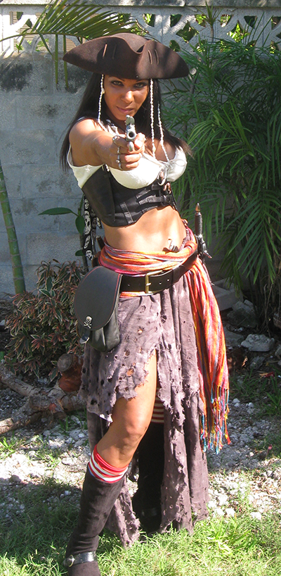 Caribbean Pearl in tattered outfit pointing a gun